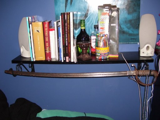 A shelf I built 8 years ago with bird feeder hangers, and a great place to display my sword.